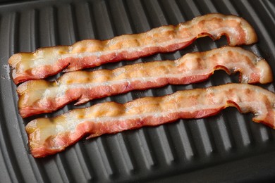 Photo of Slices of bacon on grill, closeup view