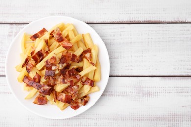 Delicious French fries with bacon on wooden rustic table, top view. Space for text