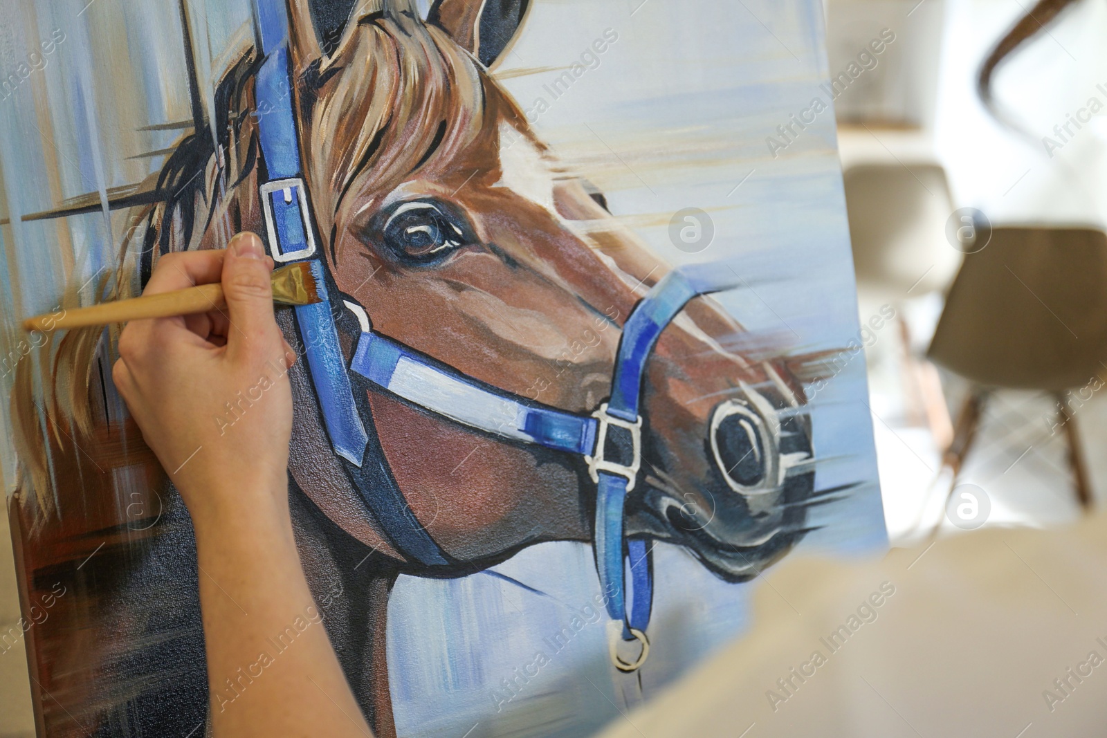 Photo of Woman drawing cute horse with brush in studio, closeup