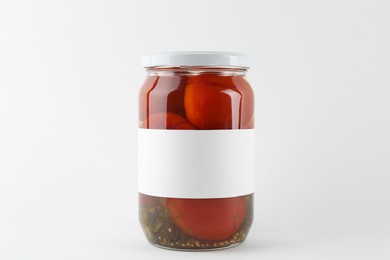 Photo of Tasty pickled tomatoes in jar on white background