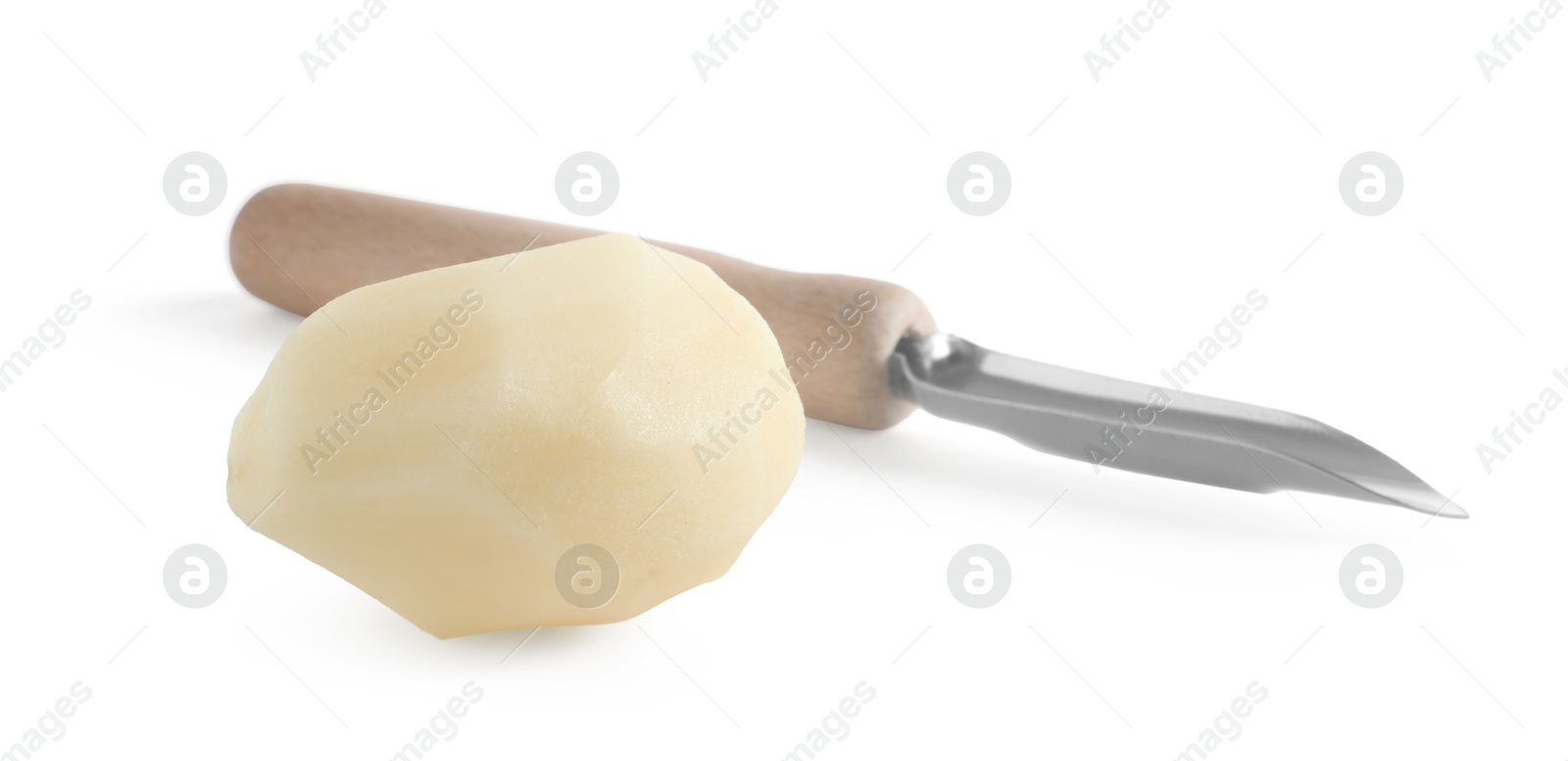 Photo of Fresh raw potato and peeler isolated on white