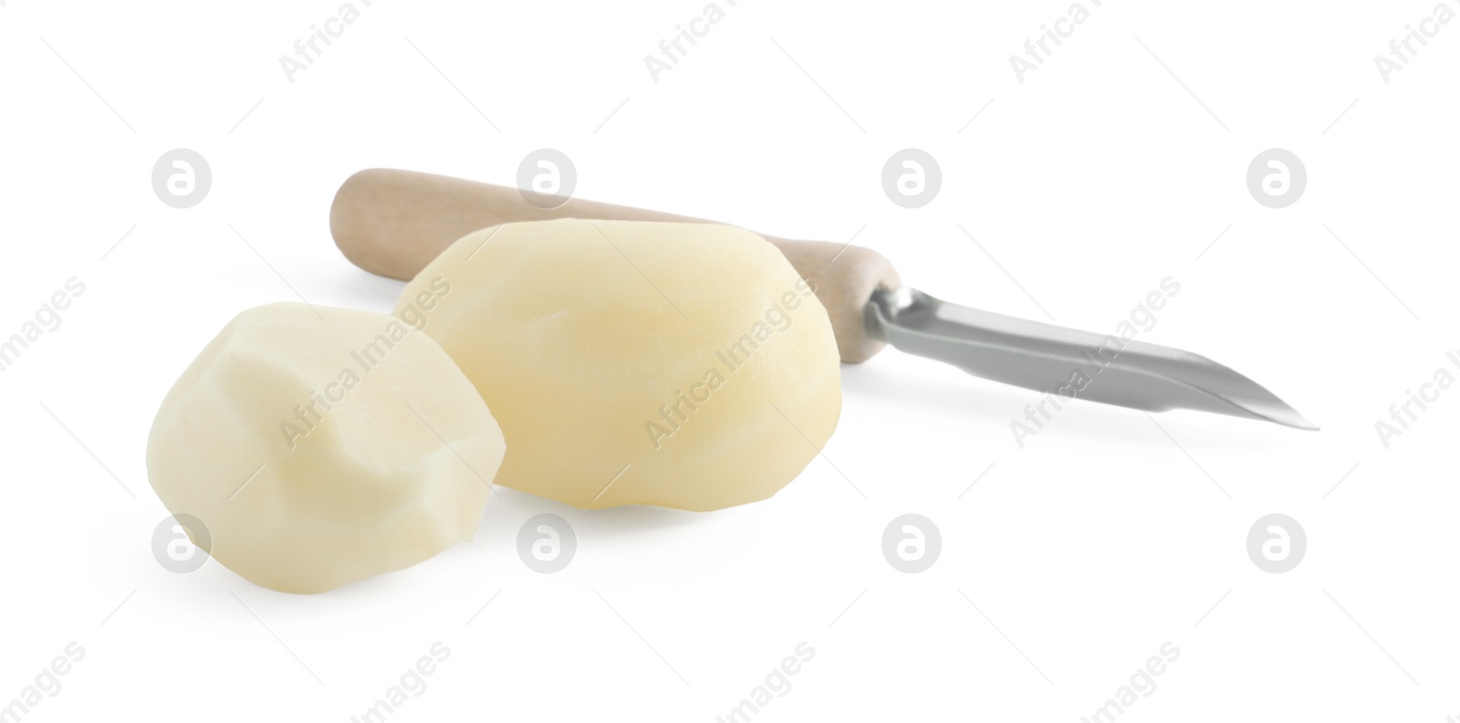 Photo of Fresh raw potatoes and peeler isolated on white