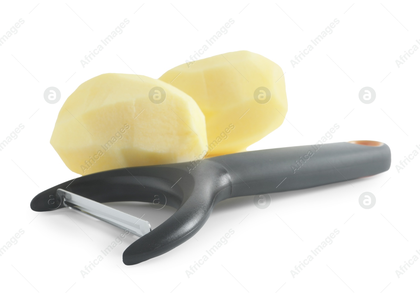 Photo of Fresh raw potatoes and peeler isolated on white