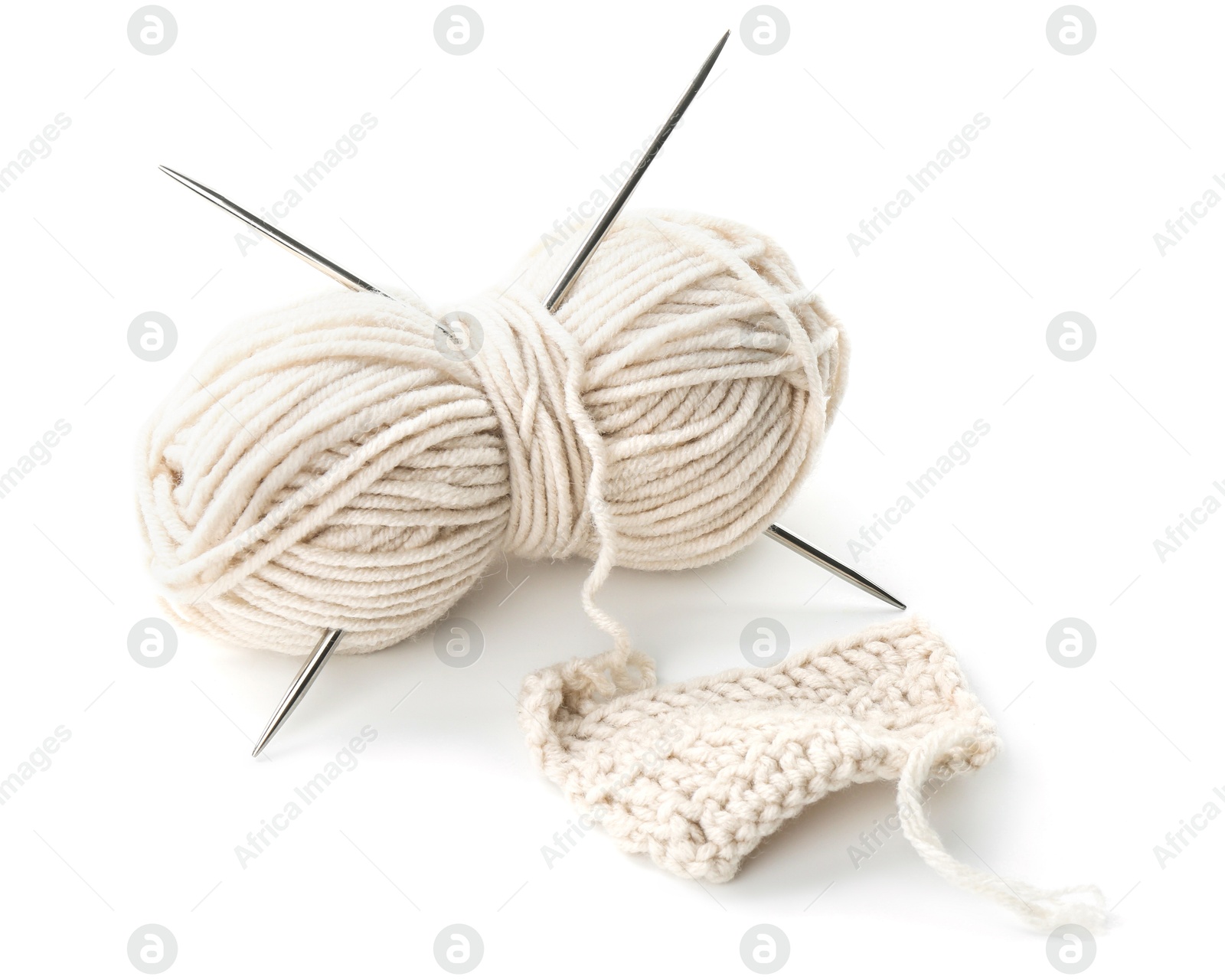 Photo of Skein of yarn with knitting needles and pattern sample isolated on white