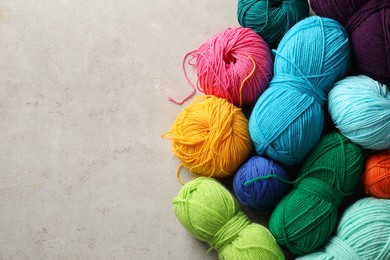 Photo of Different yarns on grey textured table, flat lay. Space for text