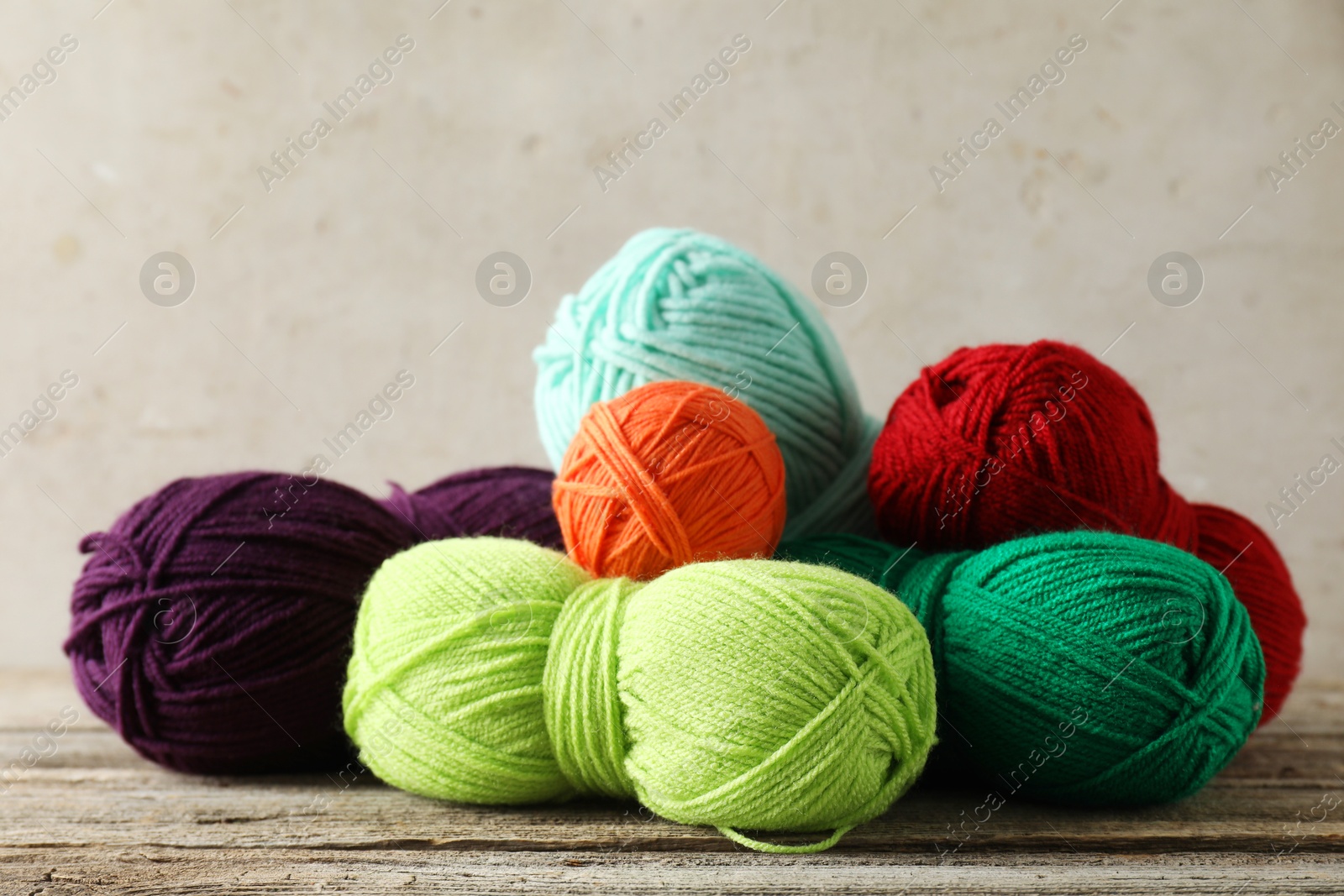 Photo of Pile of different yarns on wooden table