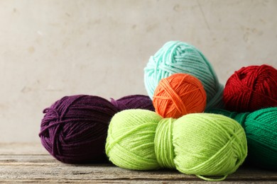 Pile of different yarns on wooden table