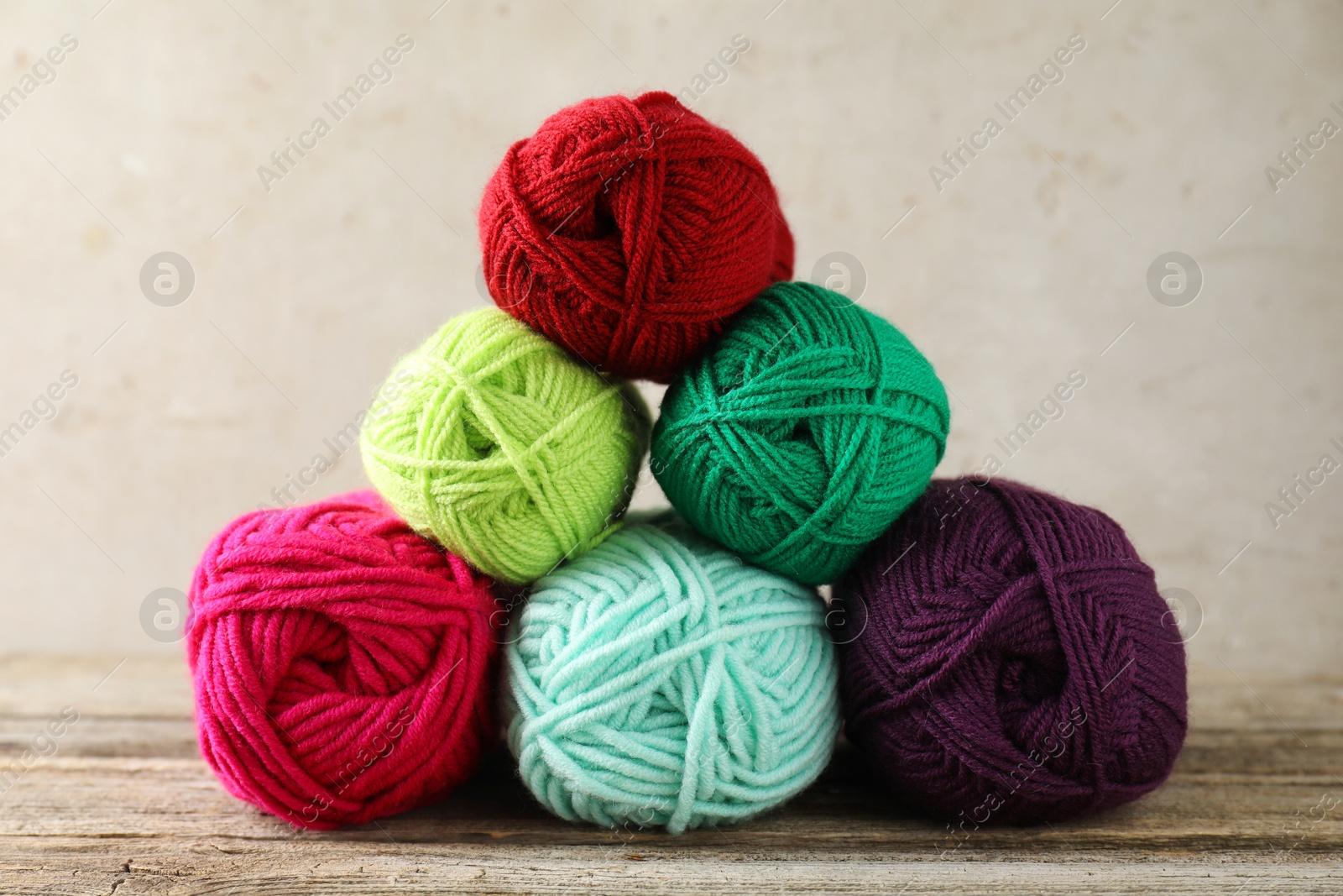 Photo of Pile of different yarns on wooden table