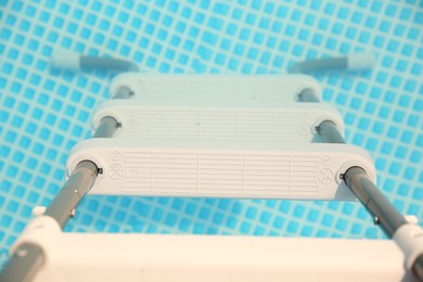 Ladder and swimming pool outdoors, above view