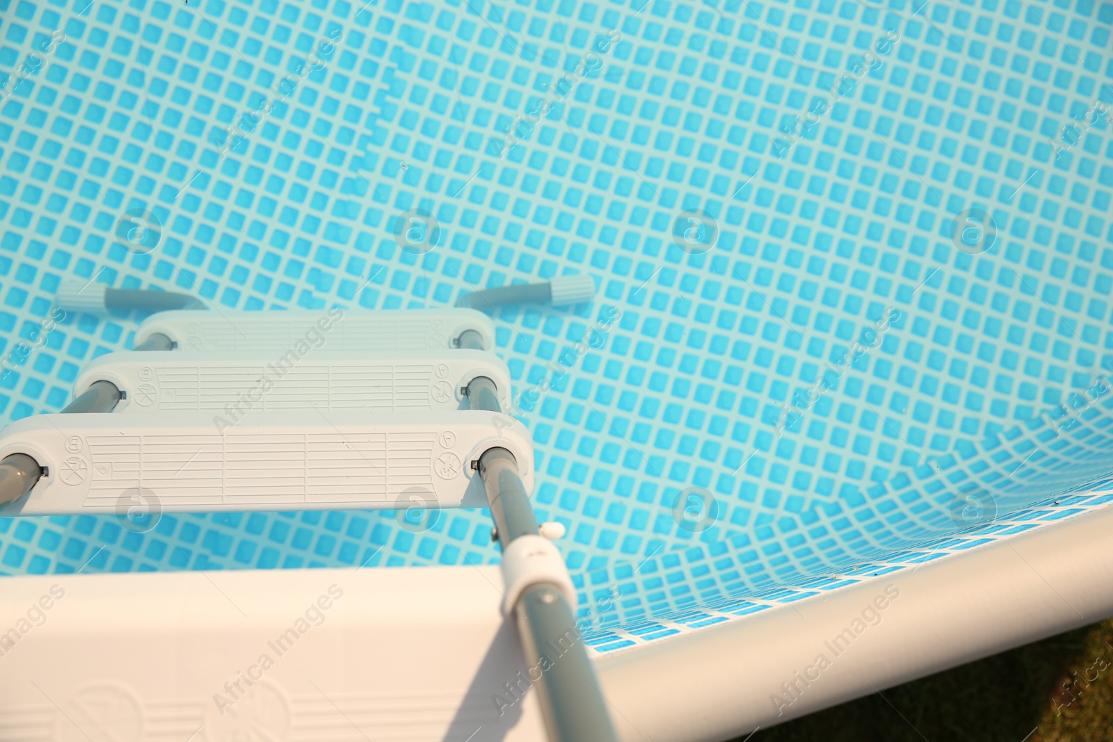 Photo of Ladder and swimming pool outdoors, above view. Space for text