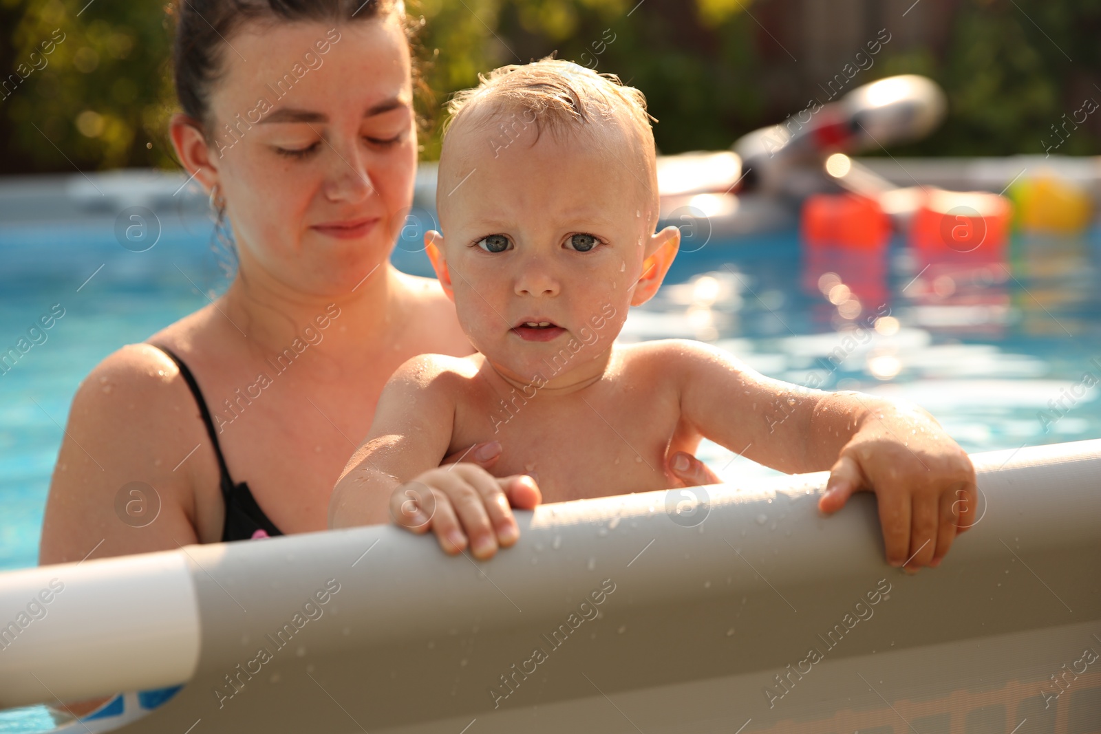 Photo of Mother and her son in swimming pool outdoors