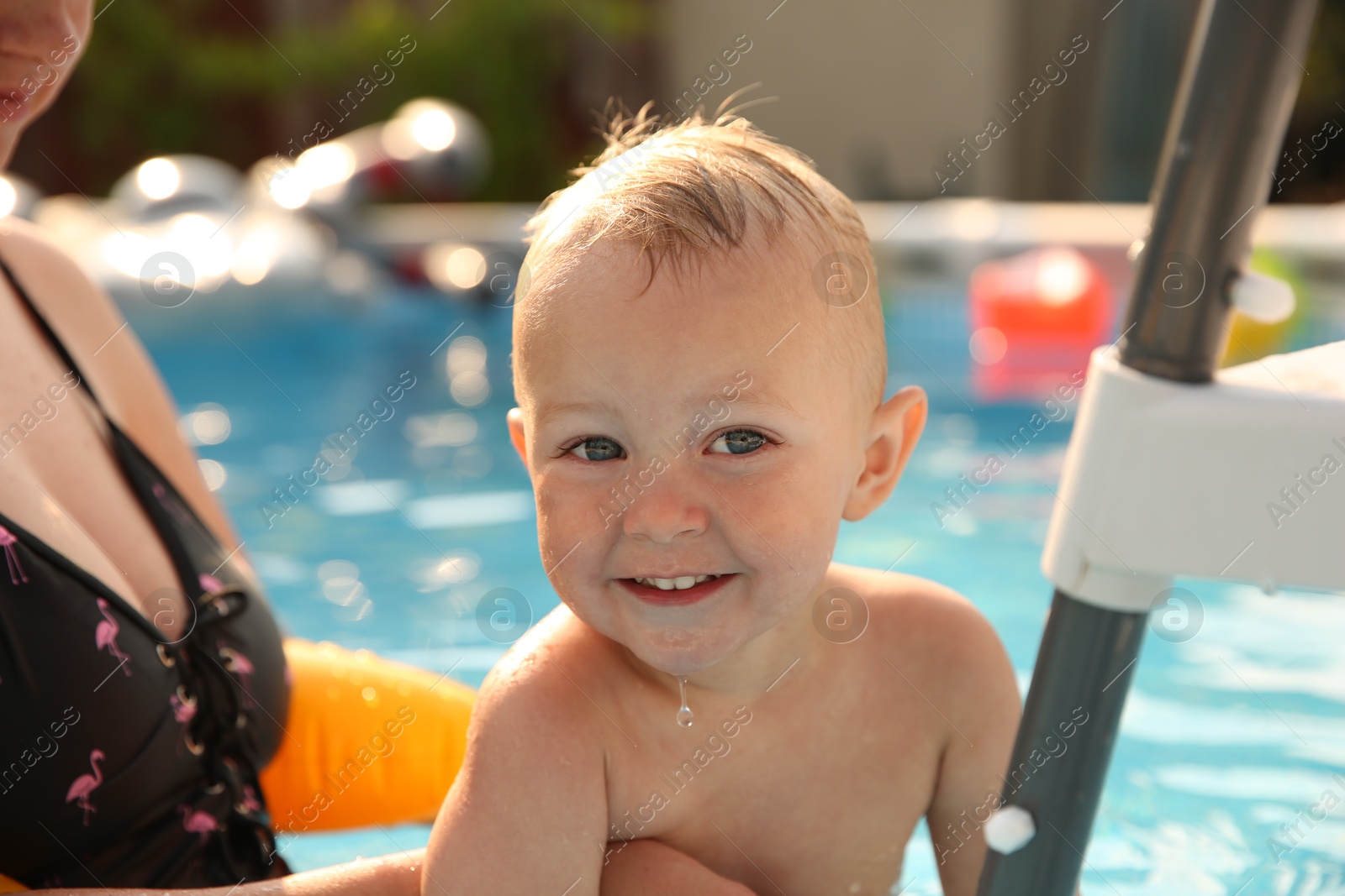 Photo of Mother and her son in swimming pool outdoors