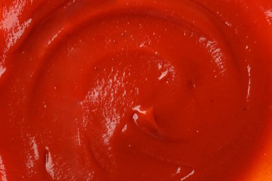 Photo of Texture of ketchup as background, top view. Tomato sauce