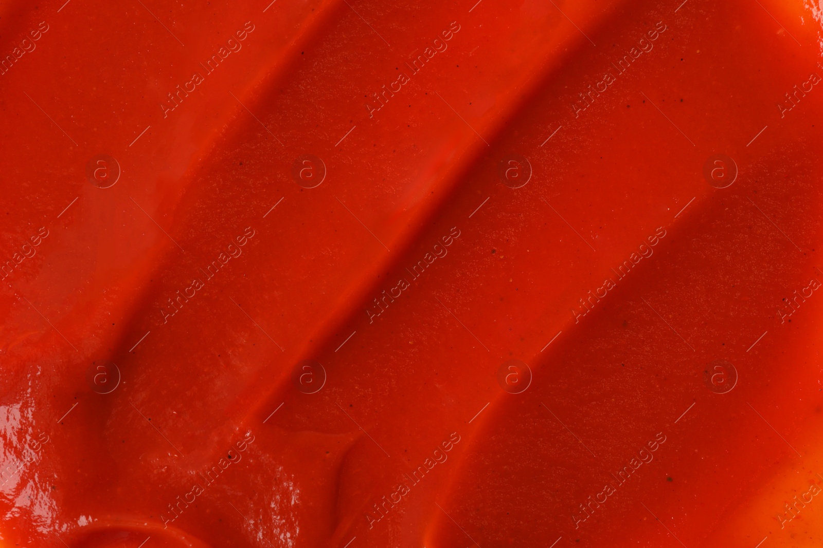 Photo of Texture of ketchup as background, top view. Tomato sauce