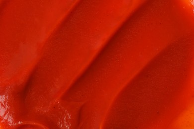 Photo of Texture of ketchup as background, top view. Tomato sauce