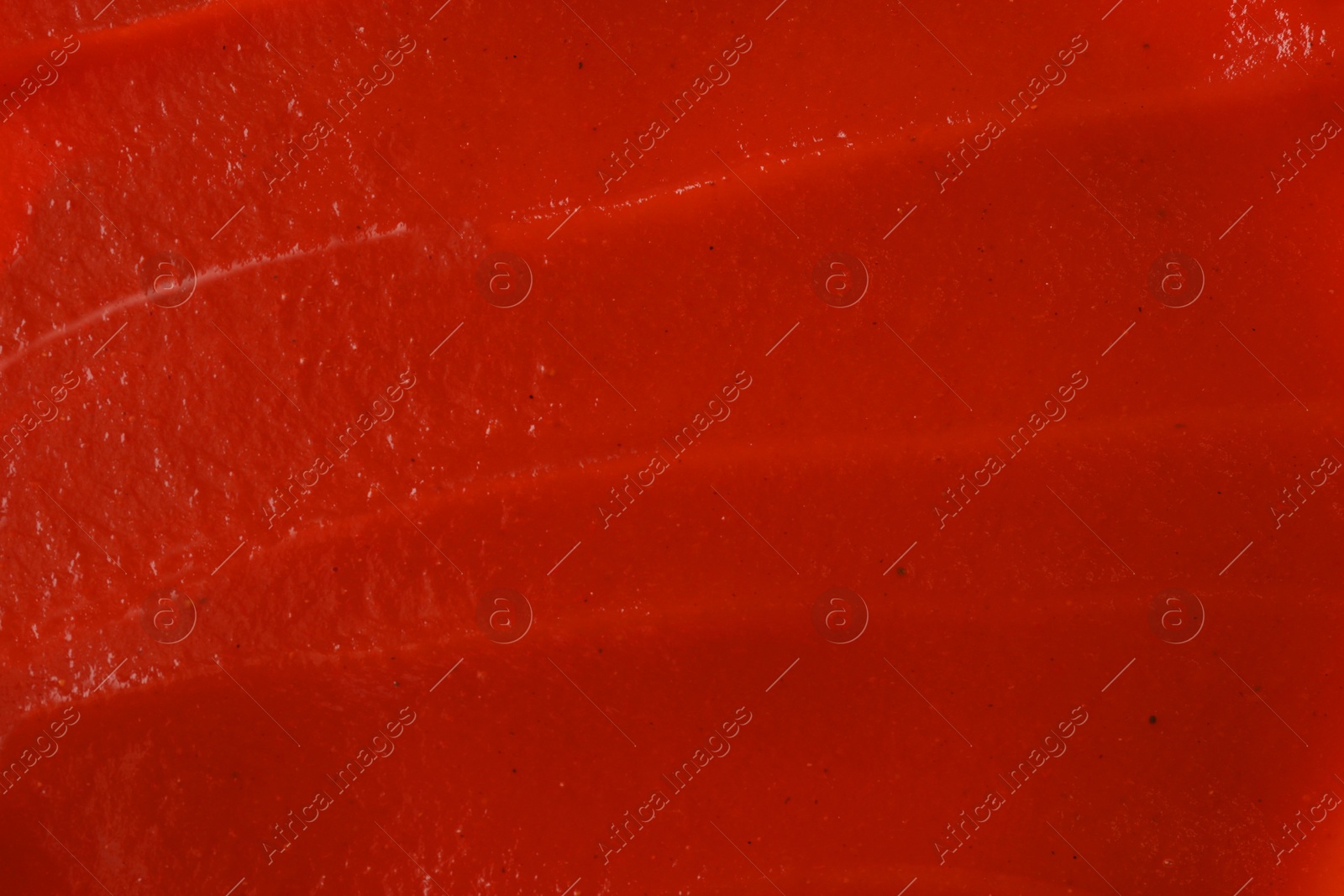 Photo of Texture of ketchup as background, top view. Tomato sauce