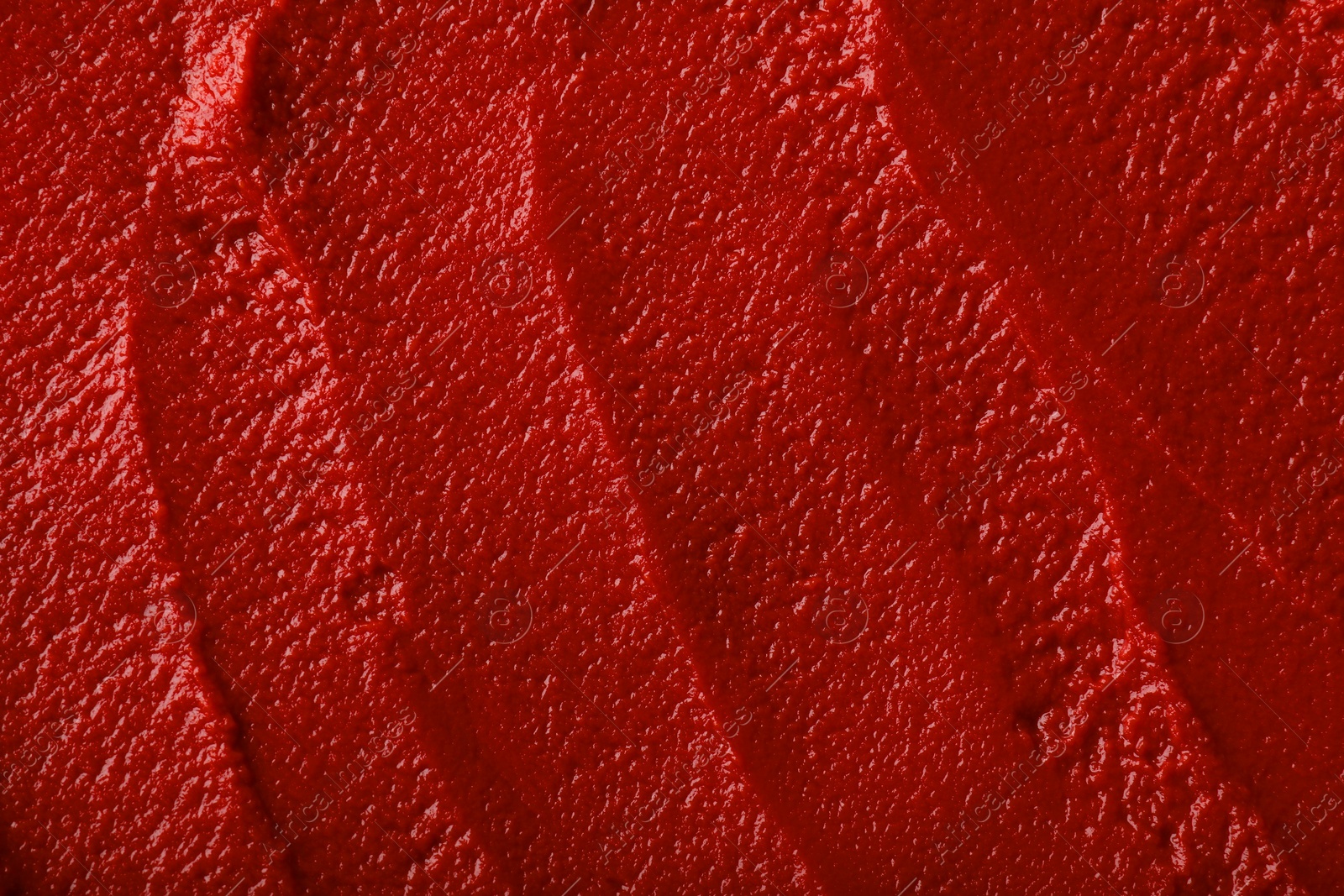 Photo of Texture of ketchup as background, top view. Tomato sauce