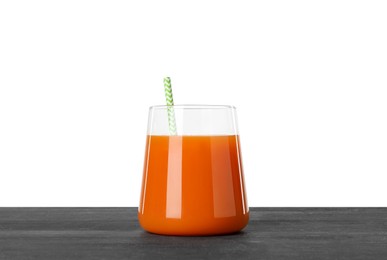 Photo of Fresh carrot juice in glass on black wooden table against white background