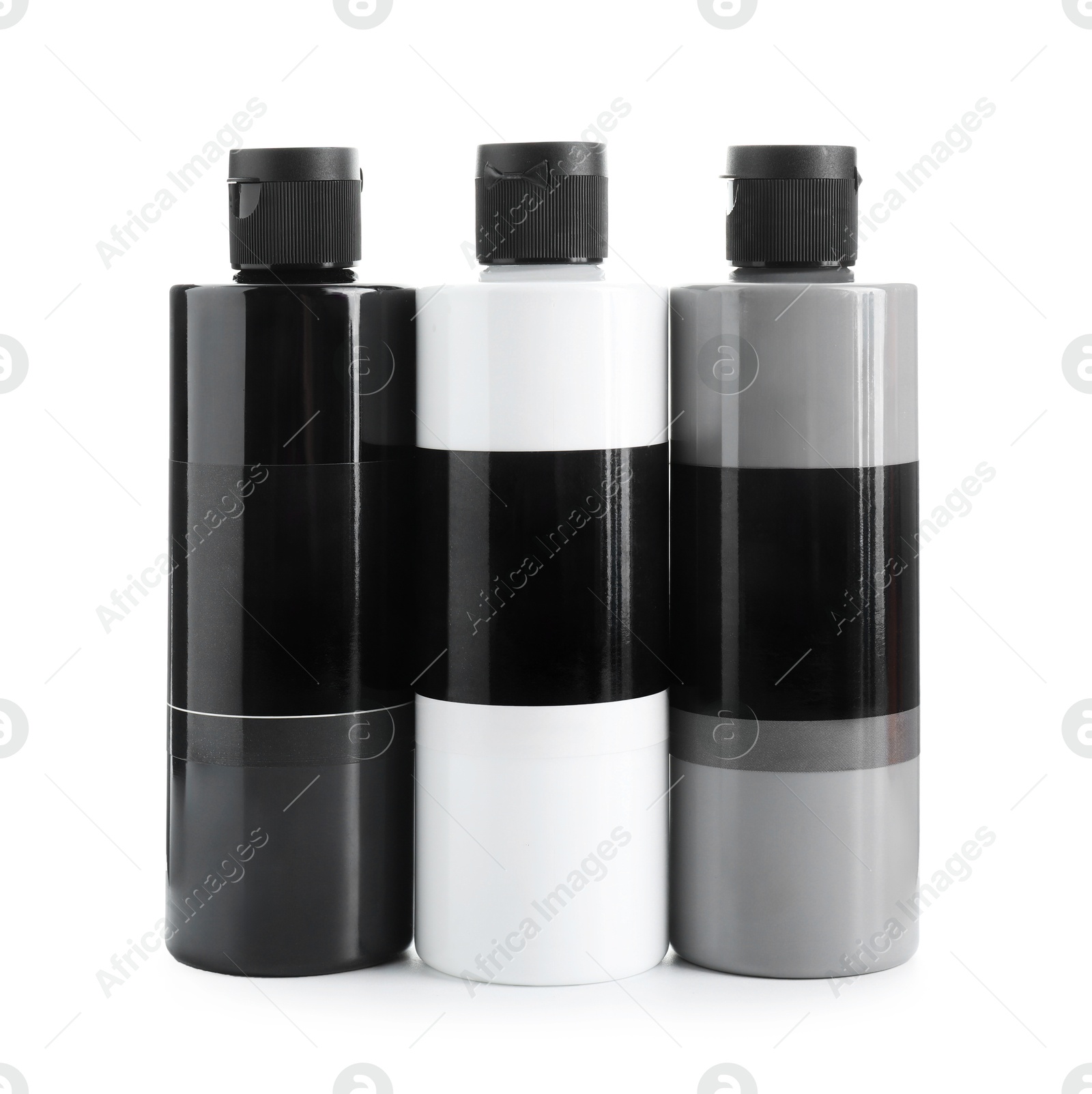 Photo of Acrylic paints of different colors in bottles isolated on white