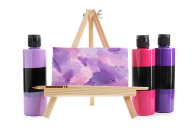 Photo of Acrylic paints of different colors in bottles and small easel with abstract picture isolated on white