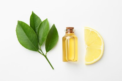 Photo of Bottle of essential oil, lemon and green leaves on white background, flat lay