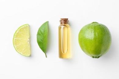 Photo of Bottle of essential oil, lime and green leaf on white background, flat lay