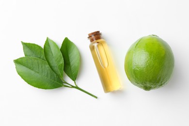 Photo of Bottle of essential oil, lime and green leaves on white background, flat lay