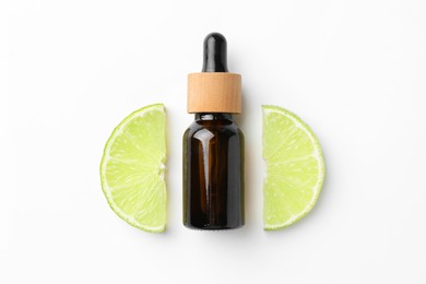 Bottle of essential oil and lime on white background, flat lay