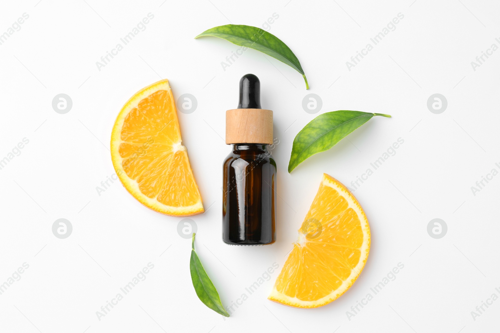 Photo of Bottle of essential oil, orange and green leaves on white background, flat lay