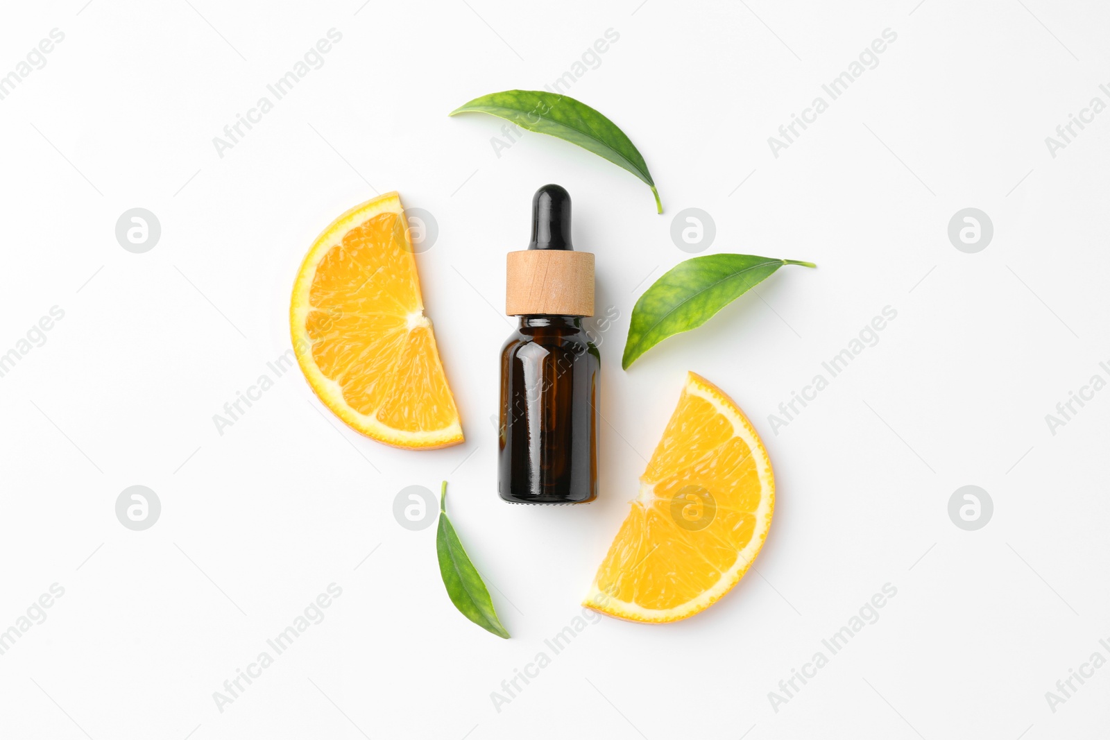 Photo of Bottle of essential oil, orange and green leaves on white background, flat lay