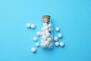 Photo of Homeopathy. Glass bottle and pills on white background, top view