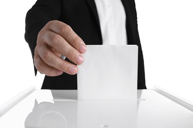 Photo of Man putting his vote into ballot box against white background, closeup