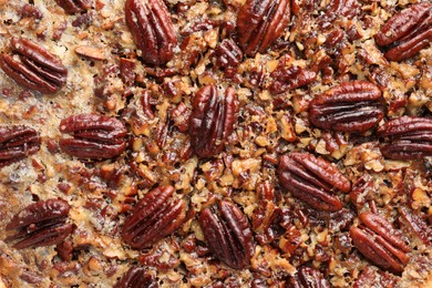 Delicious pecan pie as background, top view