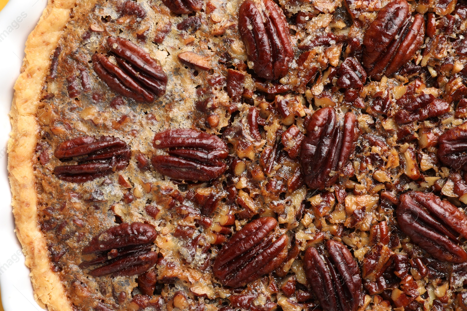 Photo of Delicious pecan pie in baking dish, top view