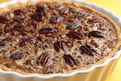 Photo of Delicious pecan pie in baking dish, closeup