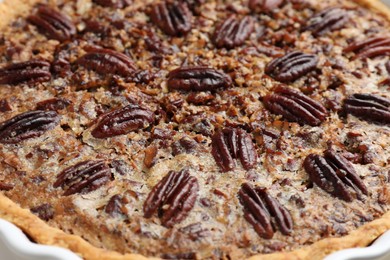 Delicious pecan pie in baking dish, closeup