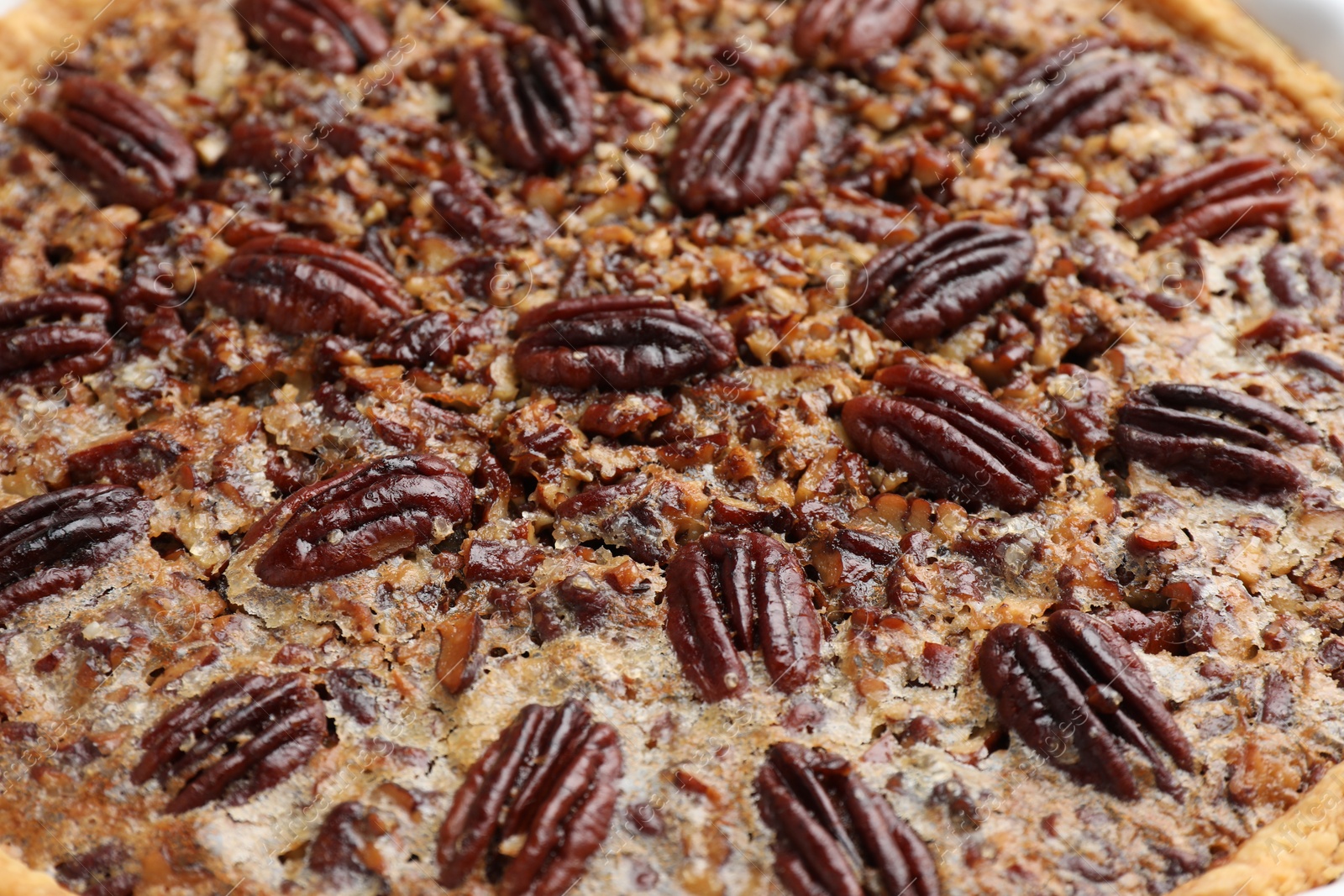 Photo of Delicious pecan pie as background, closeup view