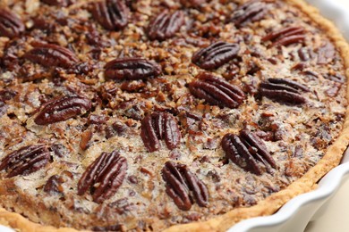 Delicious pecan pie in baking dish, closeup