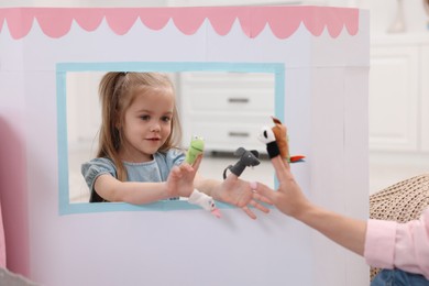 Puppet theatre. Mother and daughter performing show at home, closeup