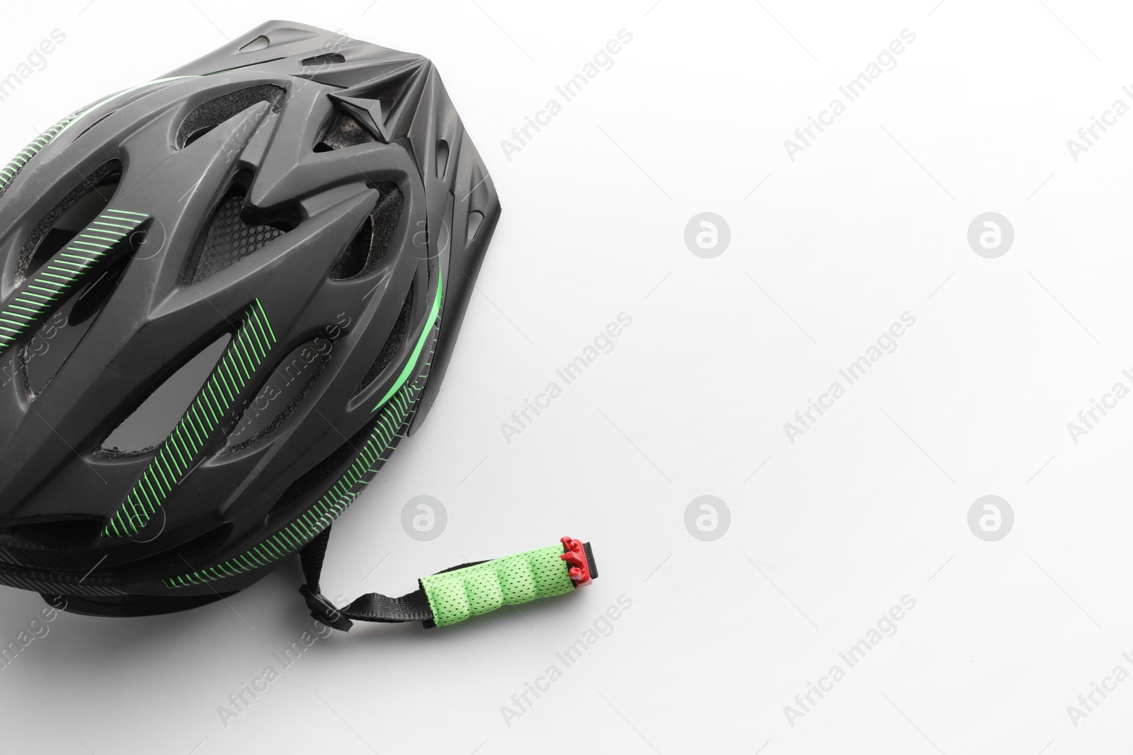 Photo of New stylish bicycle helmet on white background, top view. Space for text