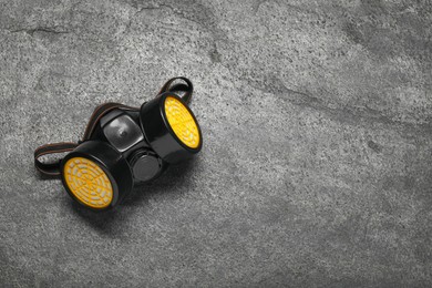 Photo of One respirator mask on grey table, top view. Space for text