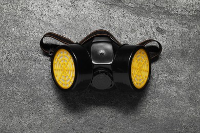 Photo of One respirator mask on grey table, top view