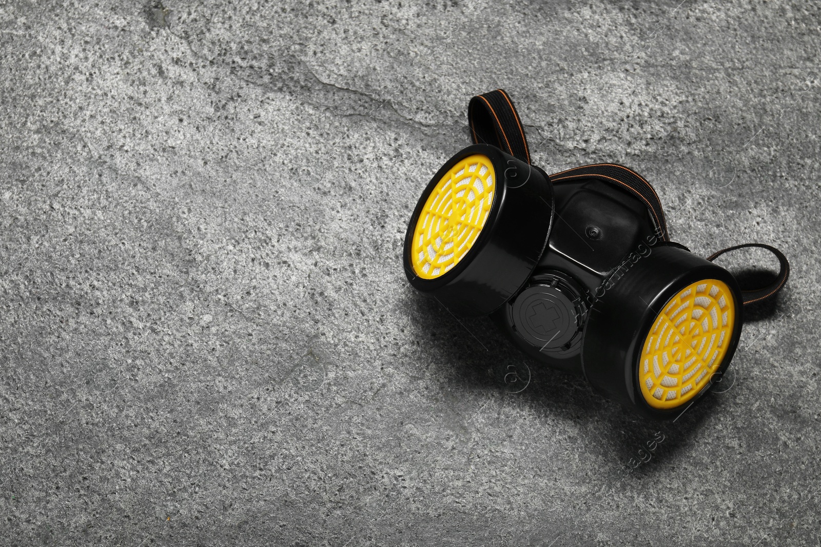 Photo of One respirator mask on grey table, top view. Space for text