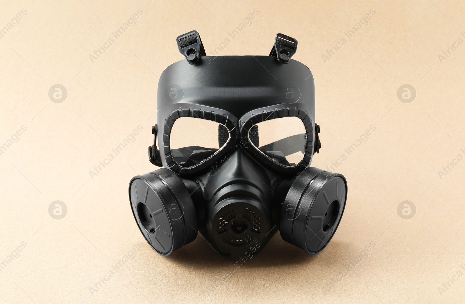 Photo of One gas mask on beige background. Safety equipment