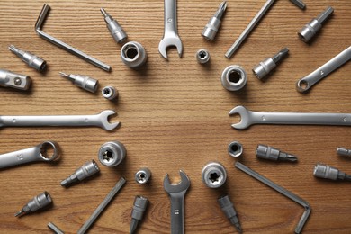 Different auto mechanic's tools on wooden table, flat lay. Space for text