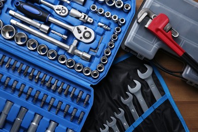 Photo of Different auto mechanic's tools on wooden table, top view