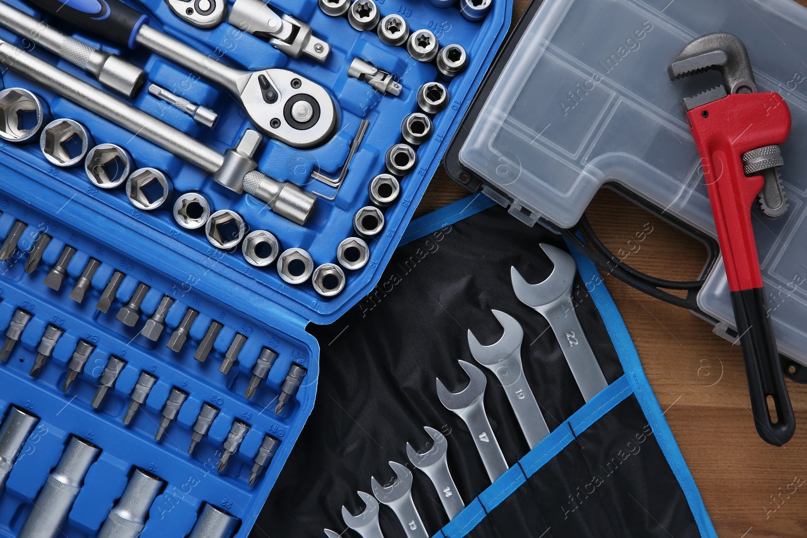 Photo of Different auto mechanic's tools on wooden table, top view