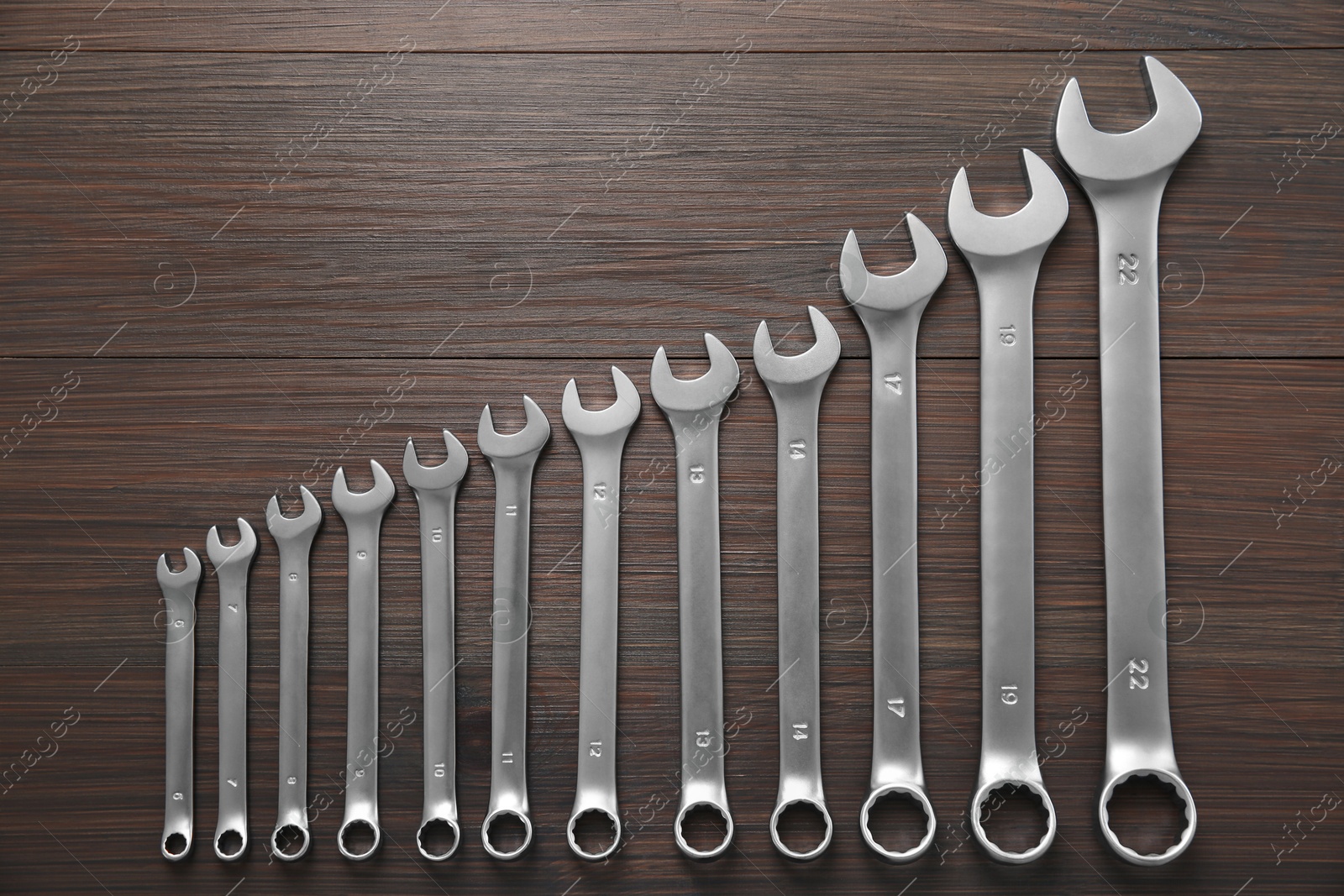 Photo of Auto mechanic's tools on wooden table, flat lay