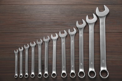 Auto mechanic's tools on wooden table, flat lay