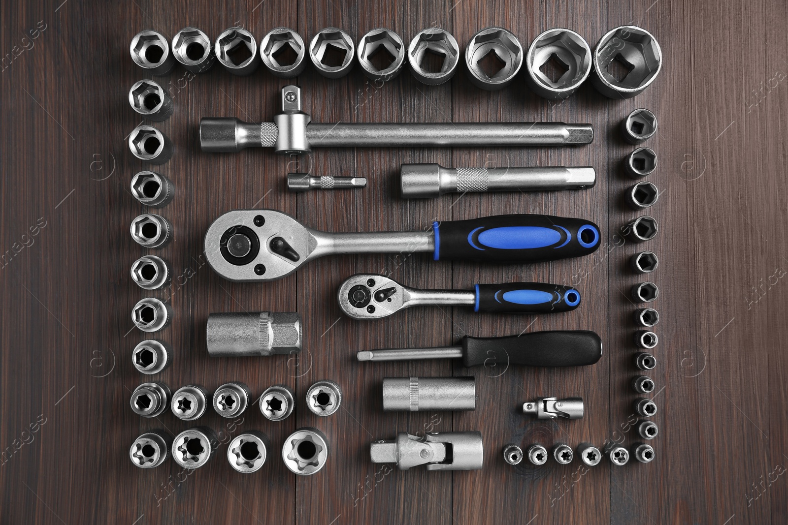 Photo of Different auto mechanic's tools on wooden table, flat lay